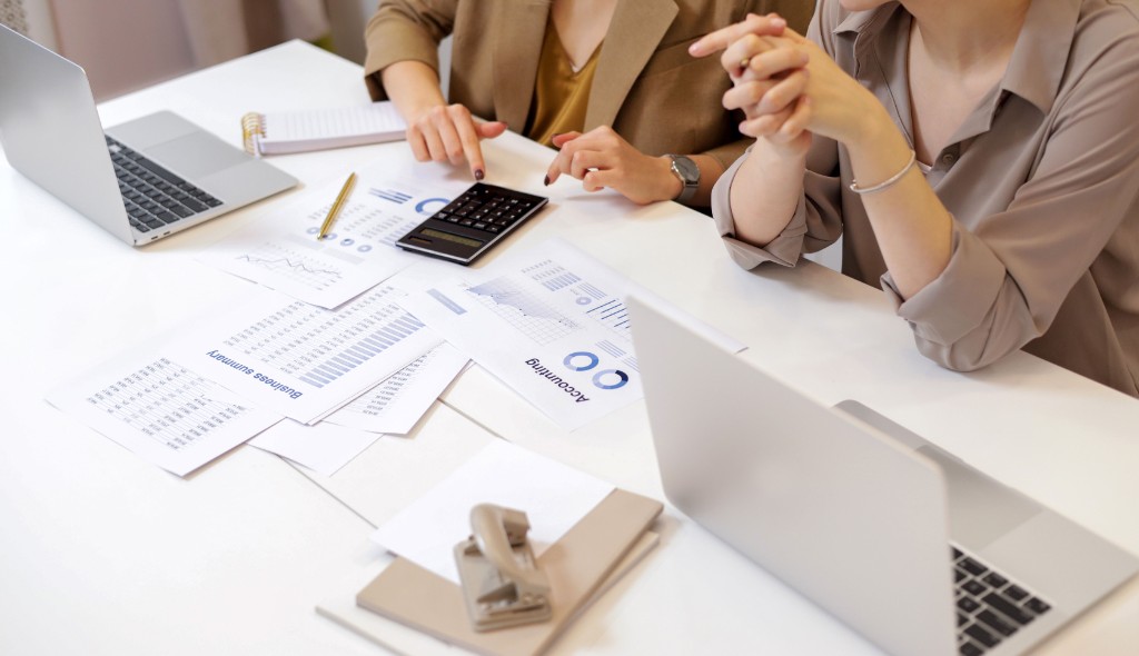 Finance professionals reviewing accounting documents together